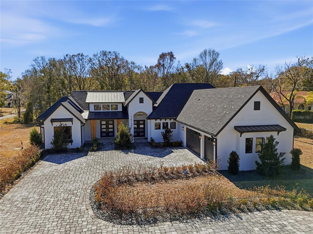 16728 Bearle Road Orlando, FL 32828 - Photo 5 of 72 a front view of a house with a garden and mountain view