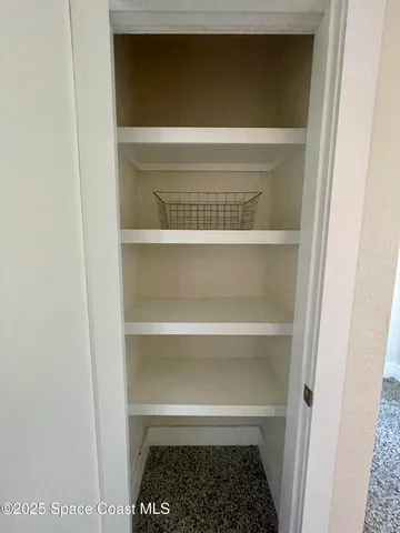 a living room with couch and a floor to ceiling window