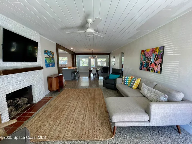 a living room with furniture fireplace and flat screen tv