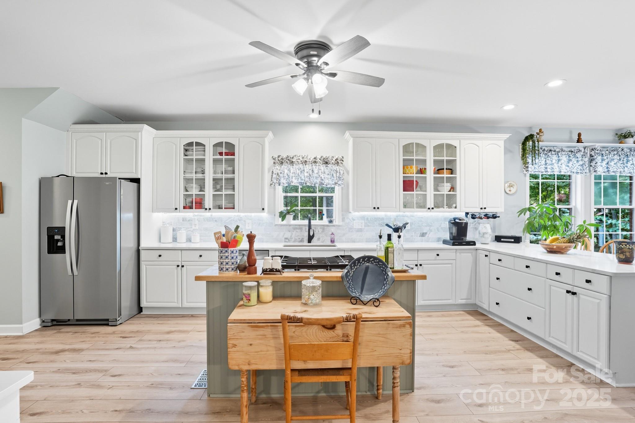 316 Brigadier Drive Clover, SC 29710 - Photo 11 of 47 a very nice looking dining room with kitchen island furniture a refrigerator a sink and wooden floor