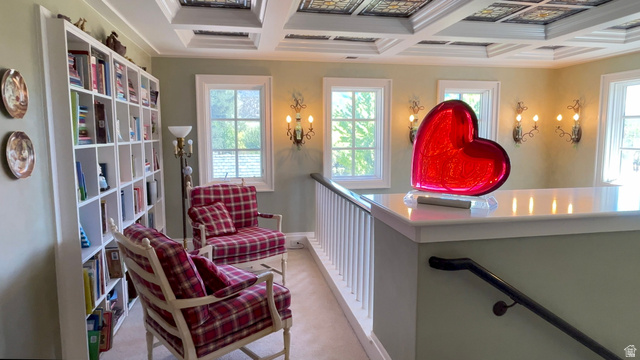 426 West Center Street Parowan, UT 84761 - Photo 44 of 107 Upper-level landing featuring a coffered ceiling with decorative panels, built-in shelving, white trim windows, wall sconces, and a white railing with a dark-toned handrail