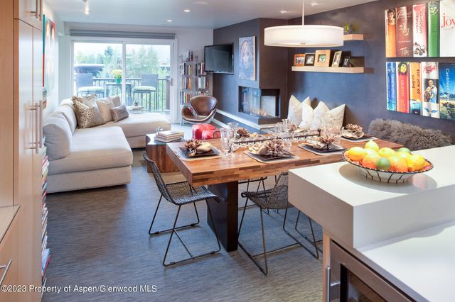 a living room with furniture kitchen view and a large window