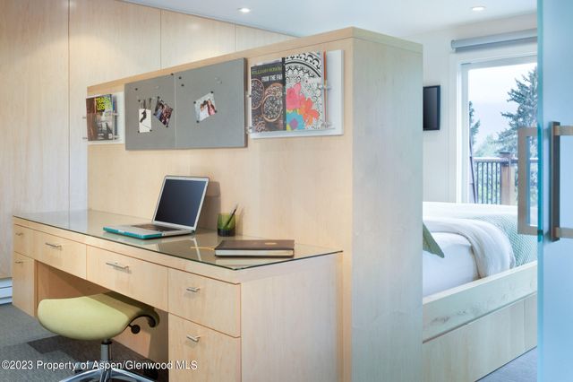 a work room with furniture and a window