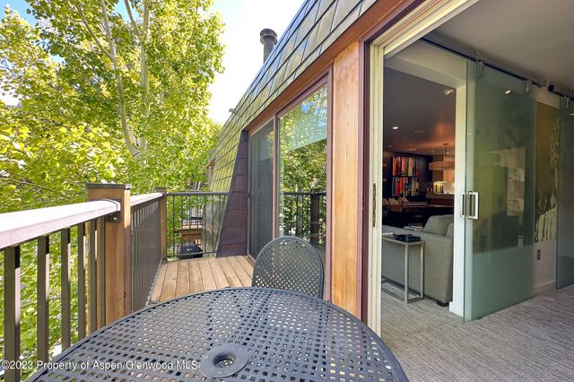 a view of a balcony with wooden floor and fence