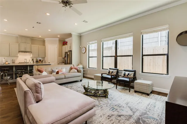 a living room with furniture and a dining table