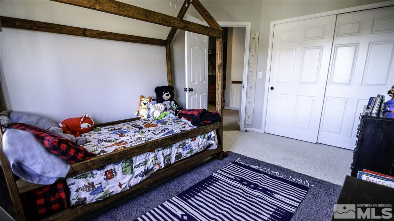 7500 Celeste Drive Reno, NV 89511 - Photo 16 of 20 a bedroom with a bed and wooden floor