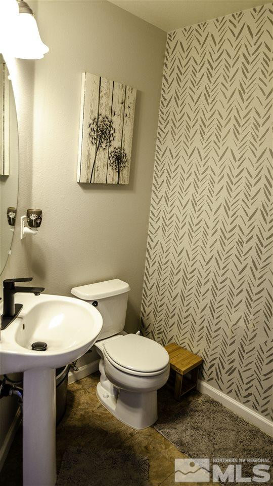 7500 Celeste Drive Reno, NV 89511 - Photo 7 of 20 a white toilet sitting next to a bathroom sink