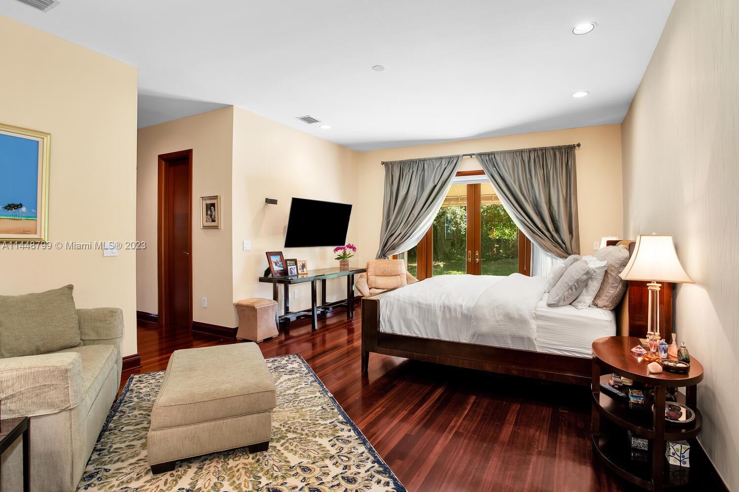 9718 Southwest 58th Court Pinecrest, FL 33156 - Photo 17 of 35 a bed room with a bed and a window