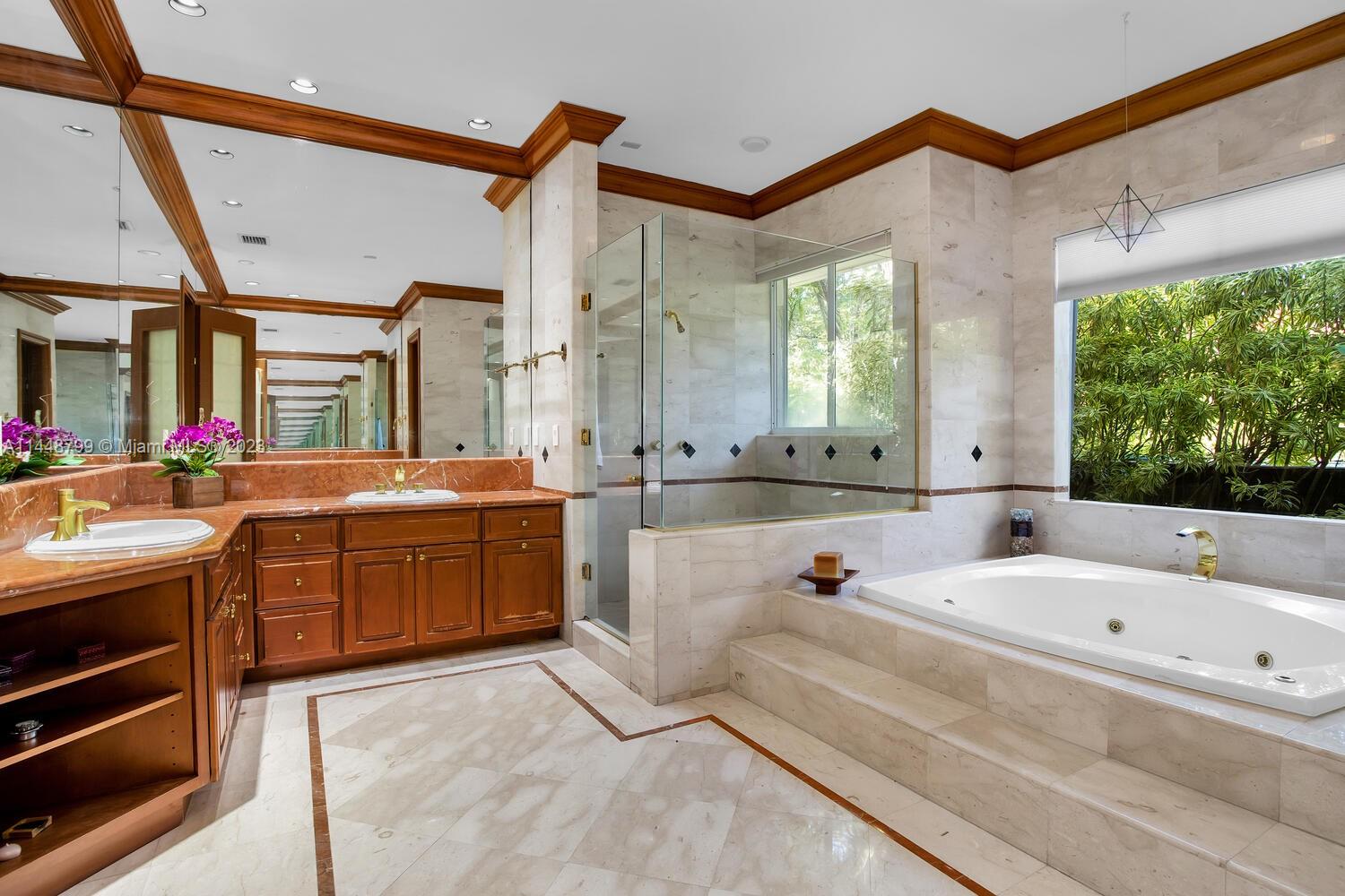 9718 Southwest 58th Court Pinecrest, FL 33156 - Photo 20 of 35 a bathroom with a tub sink and mirror