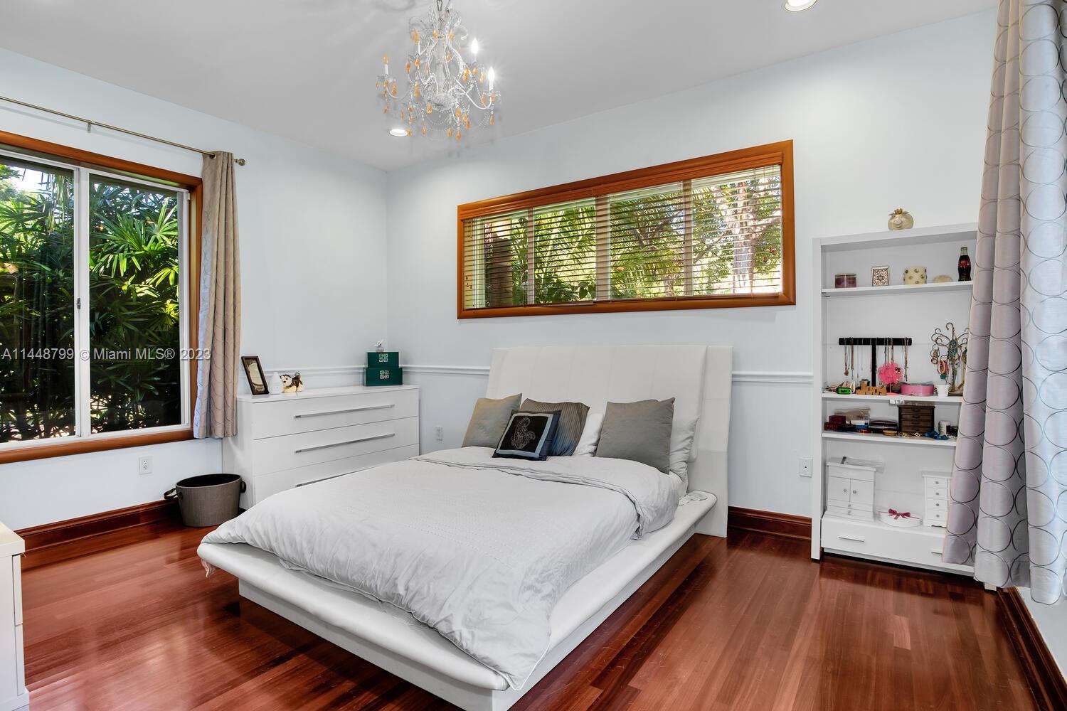 9718 Southwest 58th Court Pinecrest, FL 33156 - Photo 23 of 35 a bedroom with a bed and a window