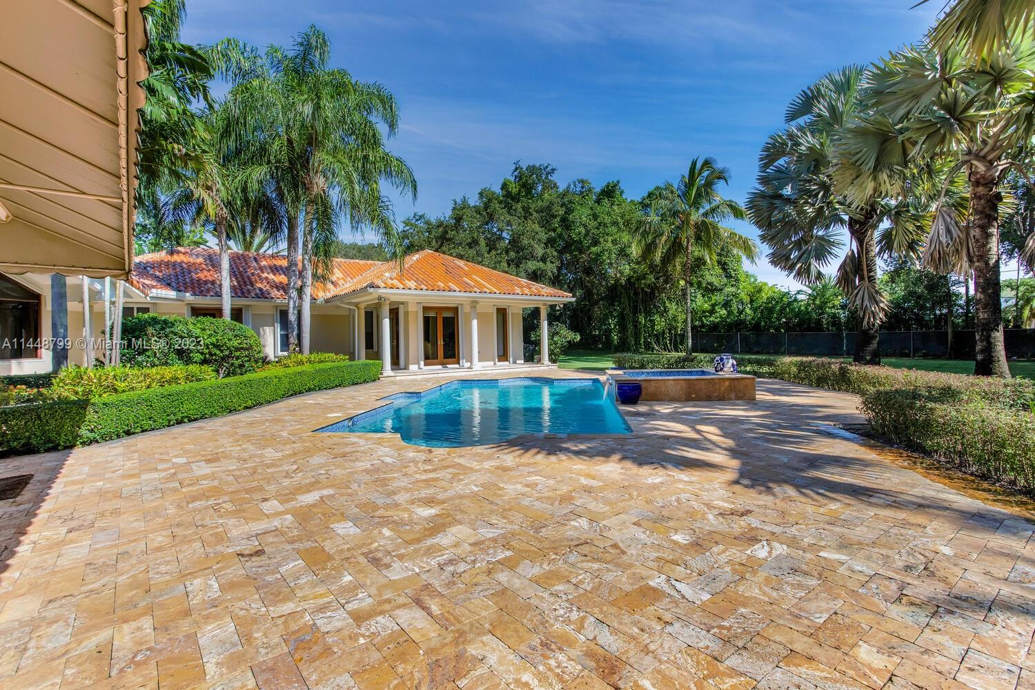 9718 Southwest 58th Court Pinecrest, FL 33156 - Photo 24 of 35 a view of swimming pool with lawn chairs and plants