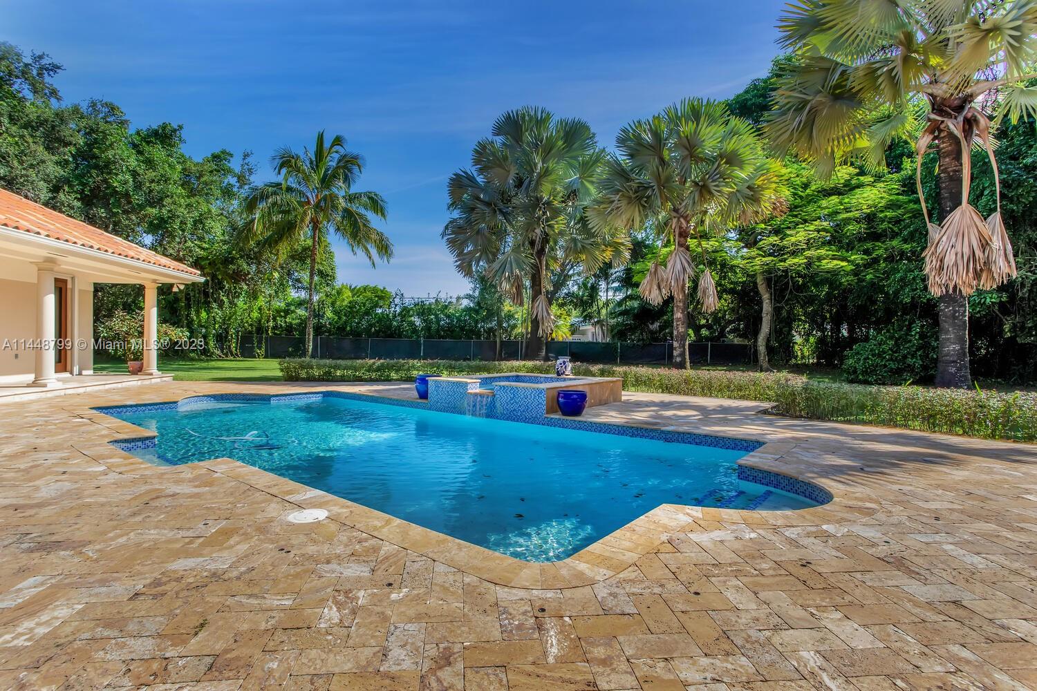 9718 Southwest 58th Court Pinecrest, FL 33156 - Photo 26 of 35 a view of a swimming pool with a yard
