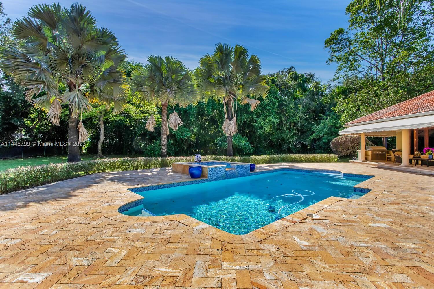 9718 Southwest 58th Court Pinecrest, FL 33156 - Photo 27 of 35 a view of a swimming pool with chair and tables