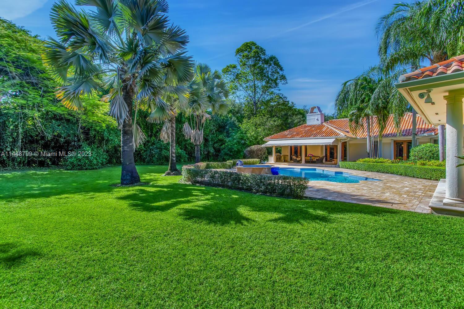 9718 Southwest 58th Court Pinecrest, FL 33156 - Photo 28 of 35 a front view of house with yard and green space