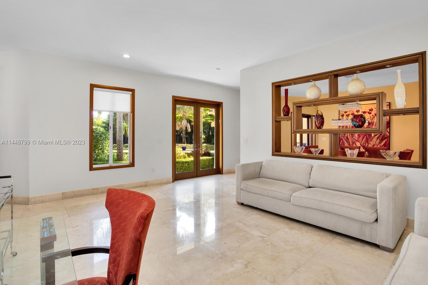 9718 Southwest 58th Court Pinecrest, FL 33156 - Photo 6 of 35 a living room with furniture and a large window