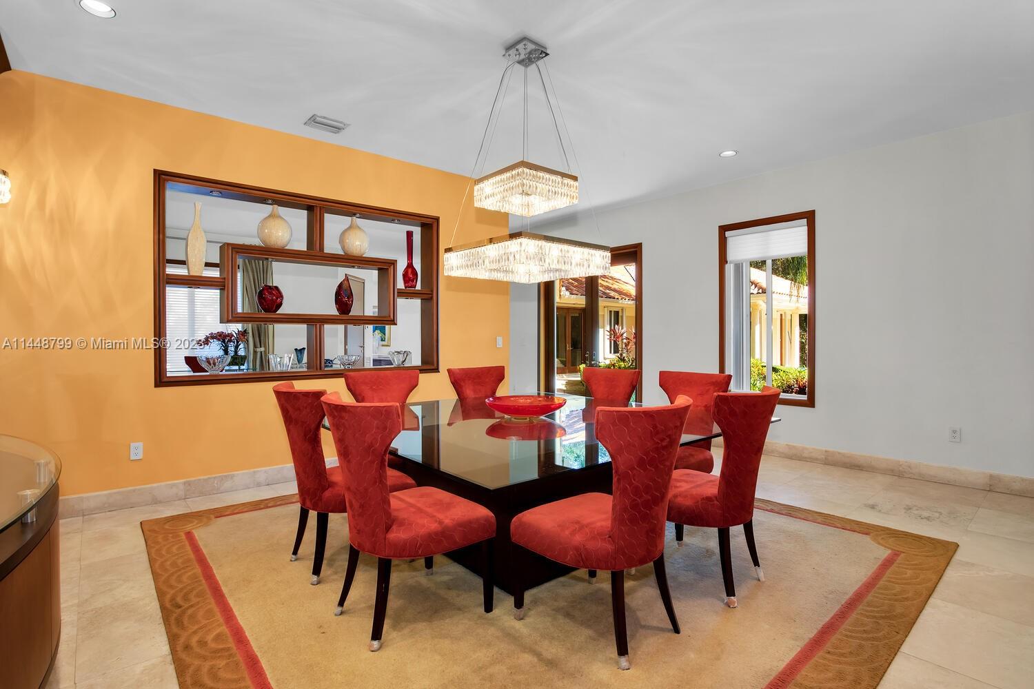 9718 Southwest 58th Court Pinecrest, FL 33156 - Photo 9 of 35 a dining room with furniture a rug and a chandelier