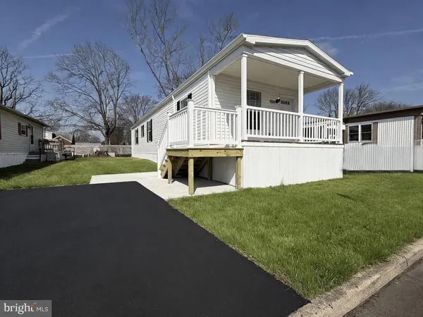 a front view of a house with a garden and yard
