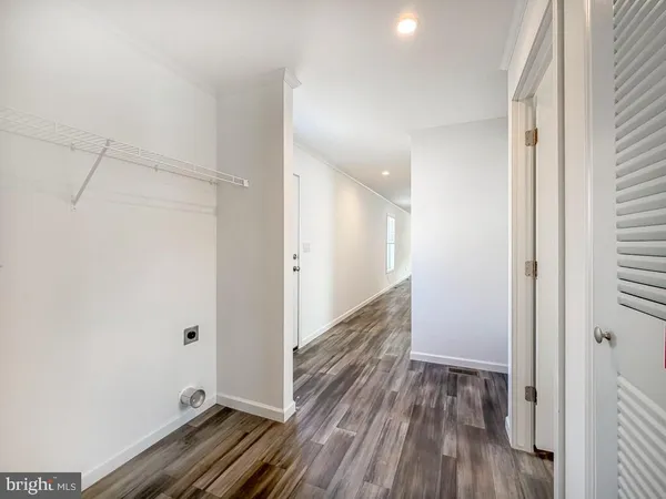 a view of hallway with wooden floor