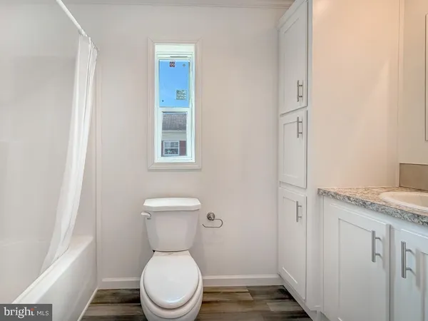a white toilet sitting next to a bathroom sink