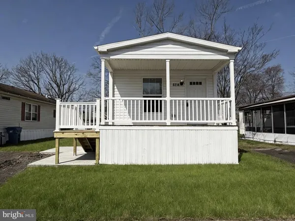 a view of a house with a yard and deck