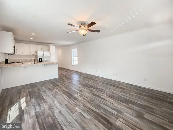 a view of a kitchen with microwave and cabinets