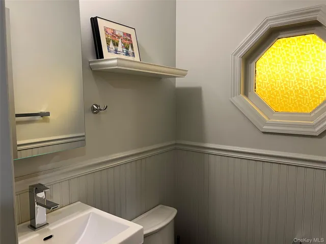 a bathroom with a sink a toilet and vanity