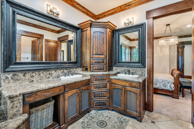 811 South High Ridge Drive Alpine, UT 84004 - Photo 28 of 98 Bathroom featuring two vanities, connected bathroom, suspended lighting, ornamental molding, and light colored carpet
