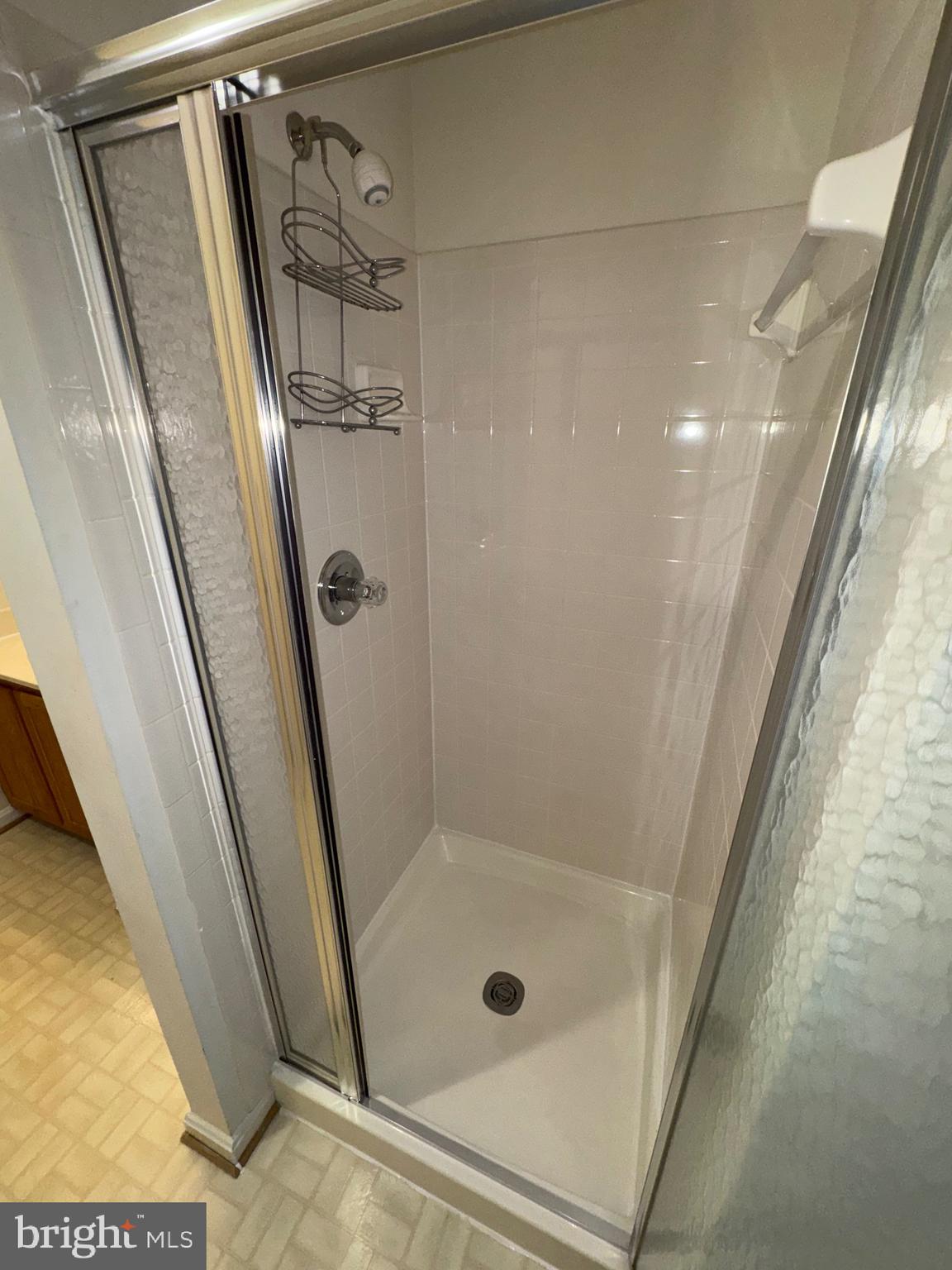 7705 Periwinkle Way, Unit 71 Severn, MD 21144 - Photo 6 of 28 a bathroom with a shower