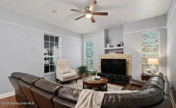 a living room with furniture a fireplace and a flat screen tv
