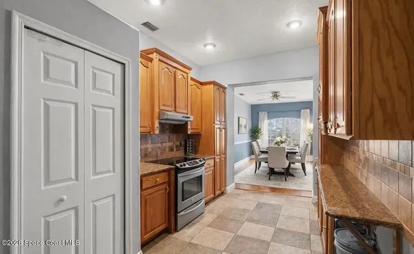 a kitchen with stainless steel appliances a refrigerator and cabinets