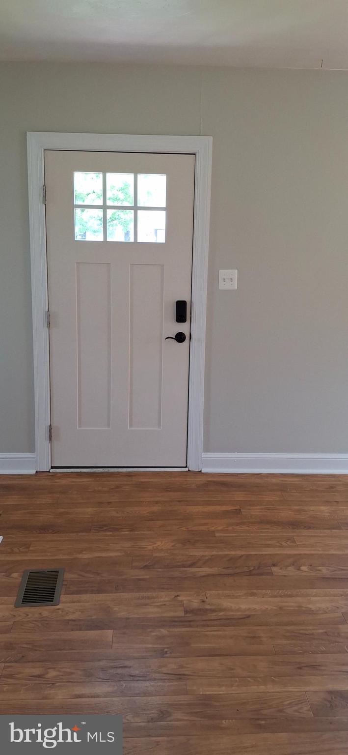 714 Crosby Road Front Royal, VA 22630 - Photo 13 of 37 a view of an empty room with wooden floor and a window
