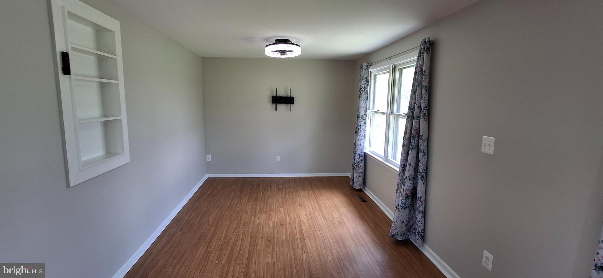 714 Crosby Road Front Royal, VA 22630 - Photo 4 of 37 an empty room with wooden floor and windows