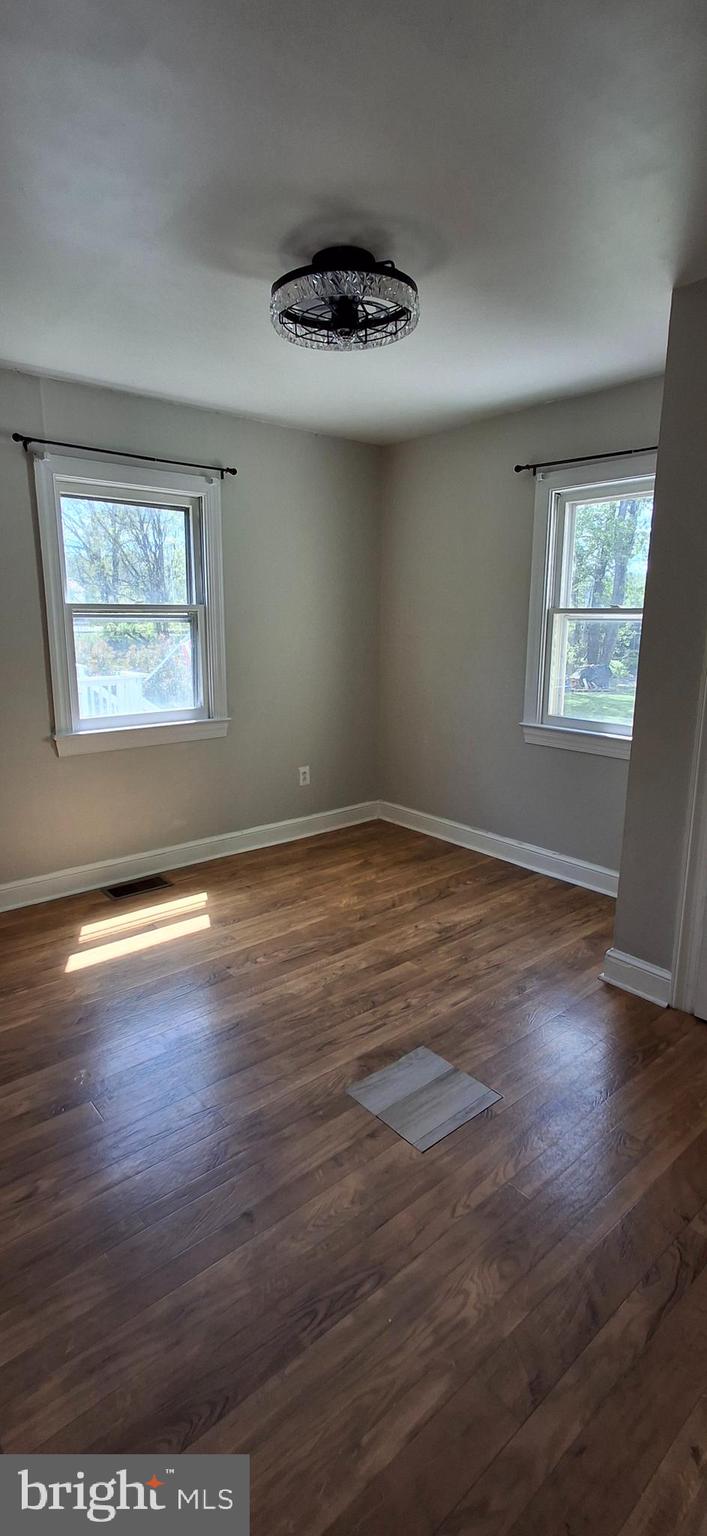 714 Crosby Road Front Royal, VA 22630 - Photo 6 of 37 an empty room with wooden floor and windows