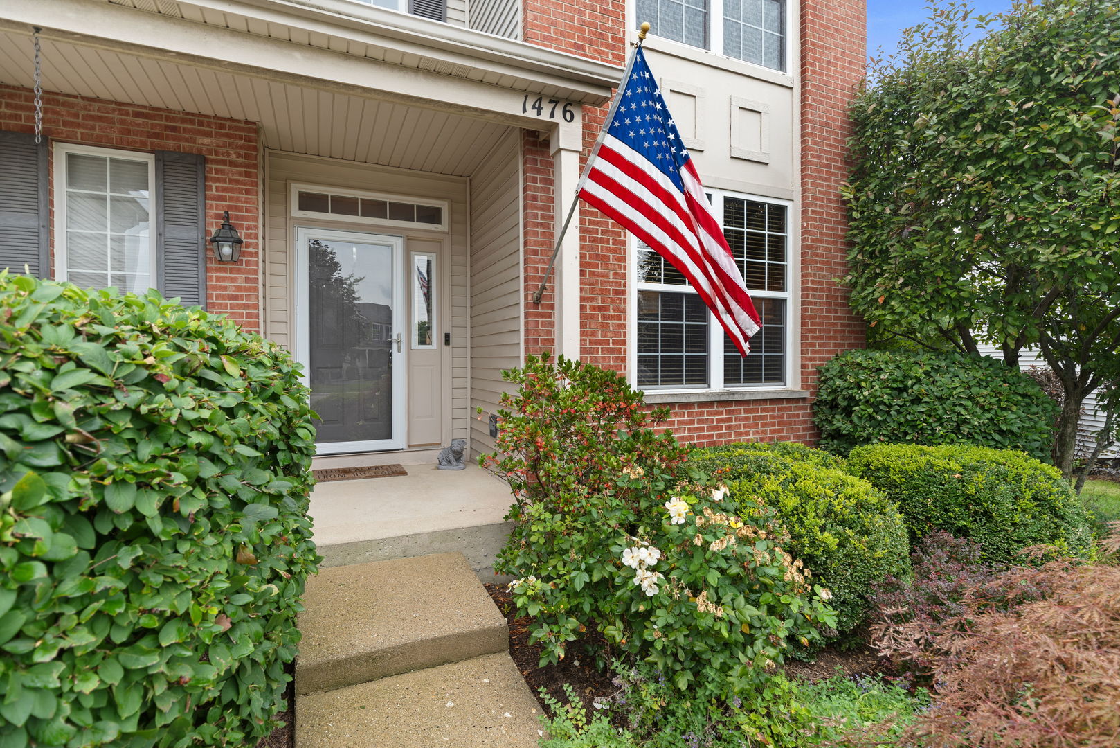1476 Wildmeadow Road Round Lake, IL 60073 - Photo 2 of 37 a front view of a house with entryway and plants