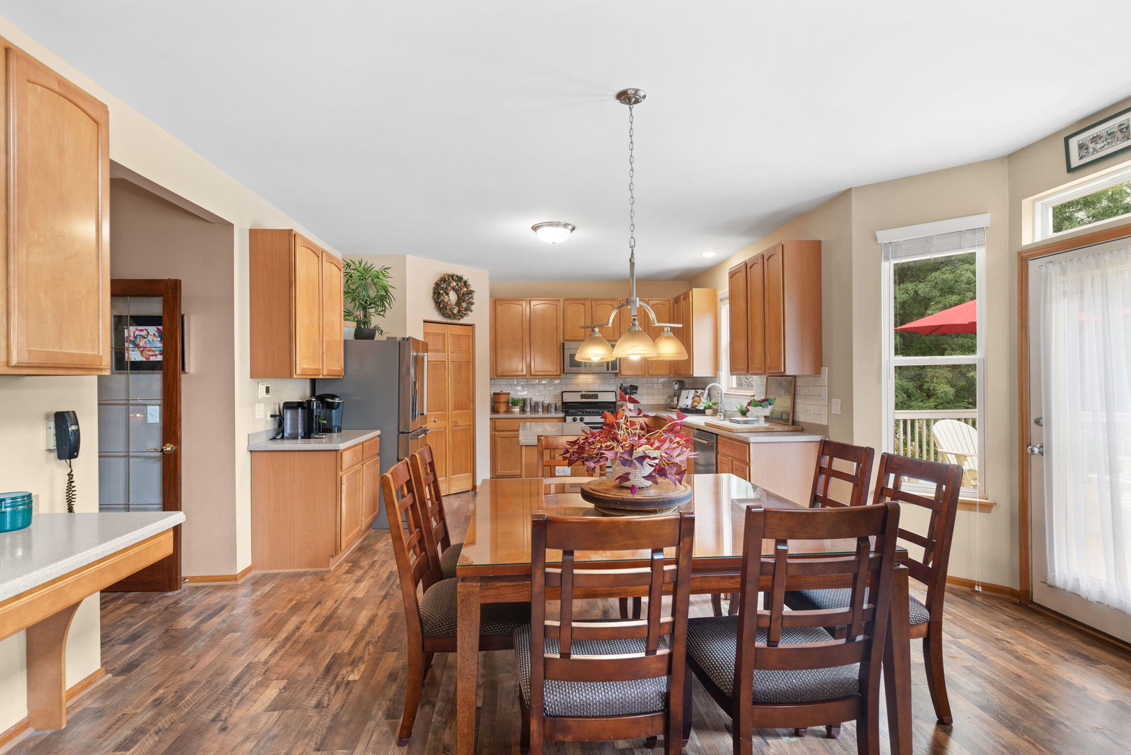 1476 Wildmeadow Road Round Lake, IL 60073 - Photo 7 of 37 a view of a dining room and livingroom with furniture wooden floor a chandelier