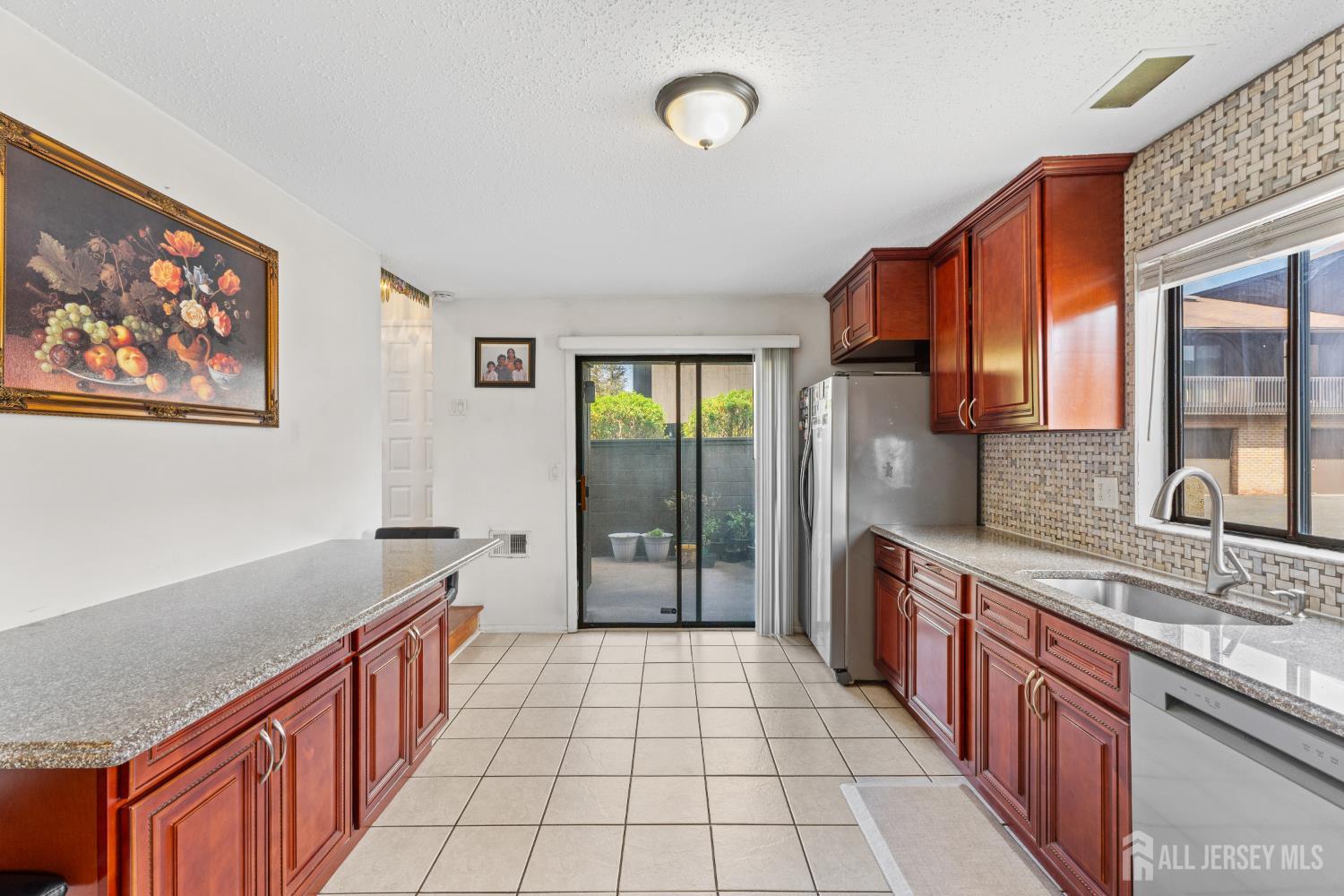 51 Westgate Drive Edison, NJ 08820 - Photo 19 of 48 a large kitchen with stainless steel appliances a large counter top a sink a stove a refrigerator and cabinets