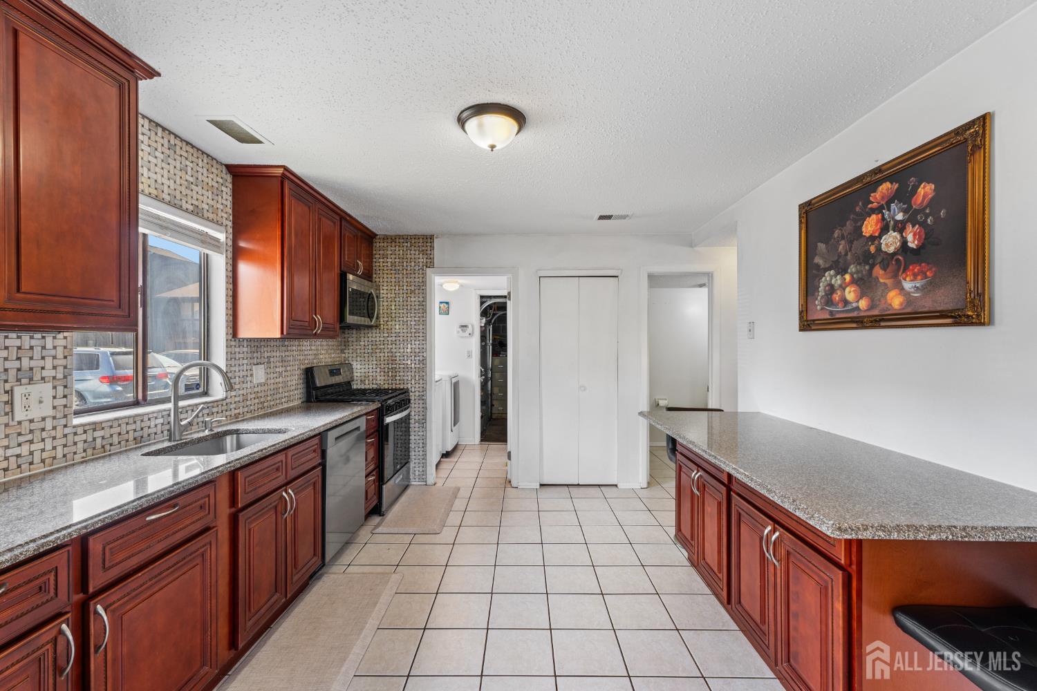 51 Westgate Drive Edison, NJ 08820 - Photo 20 of 48 a large kitchen with stainless steel appliances granite countertop a sink and cabinets