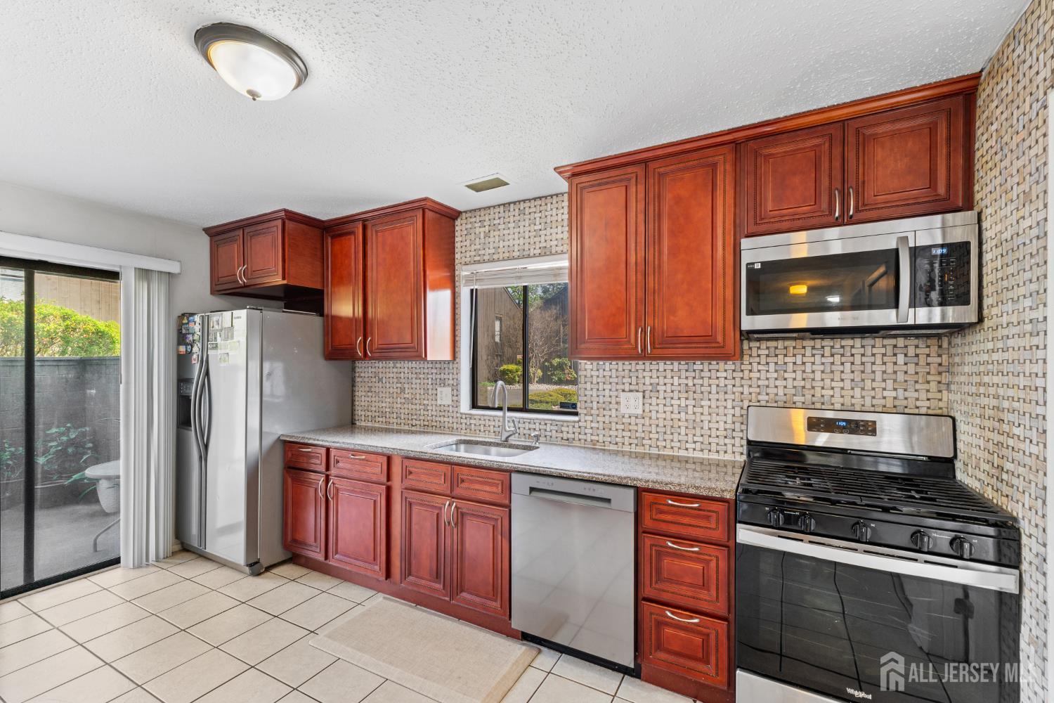51 Westgate Drive Edison, NJ 08820 - Photo 21 of 48 a kitchen with stainless steel appliances granite countertop a stove sink microwave and refrigerator