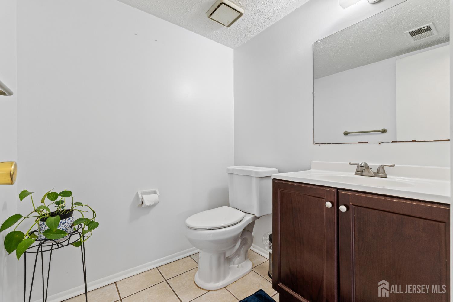 51 Westgate Drive Edison, NJ 08820 - Photo 23 of 48 a bathroom with a granite countertop toilet sink and mirror