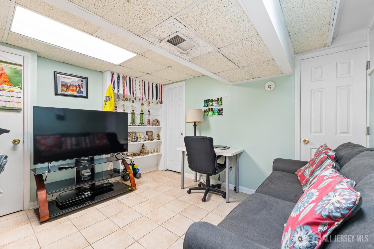 51 Westgate Drive Edison, NJ 08820 - Photo 24 of 48 a living room with furniture and a flat screen tv