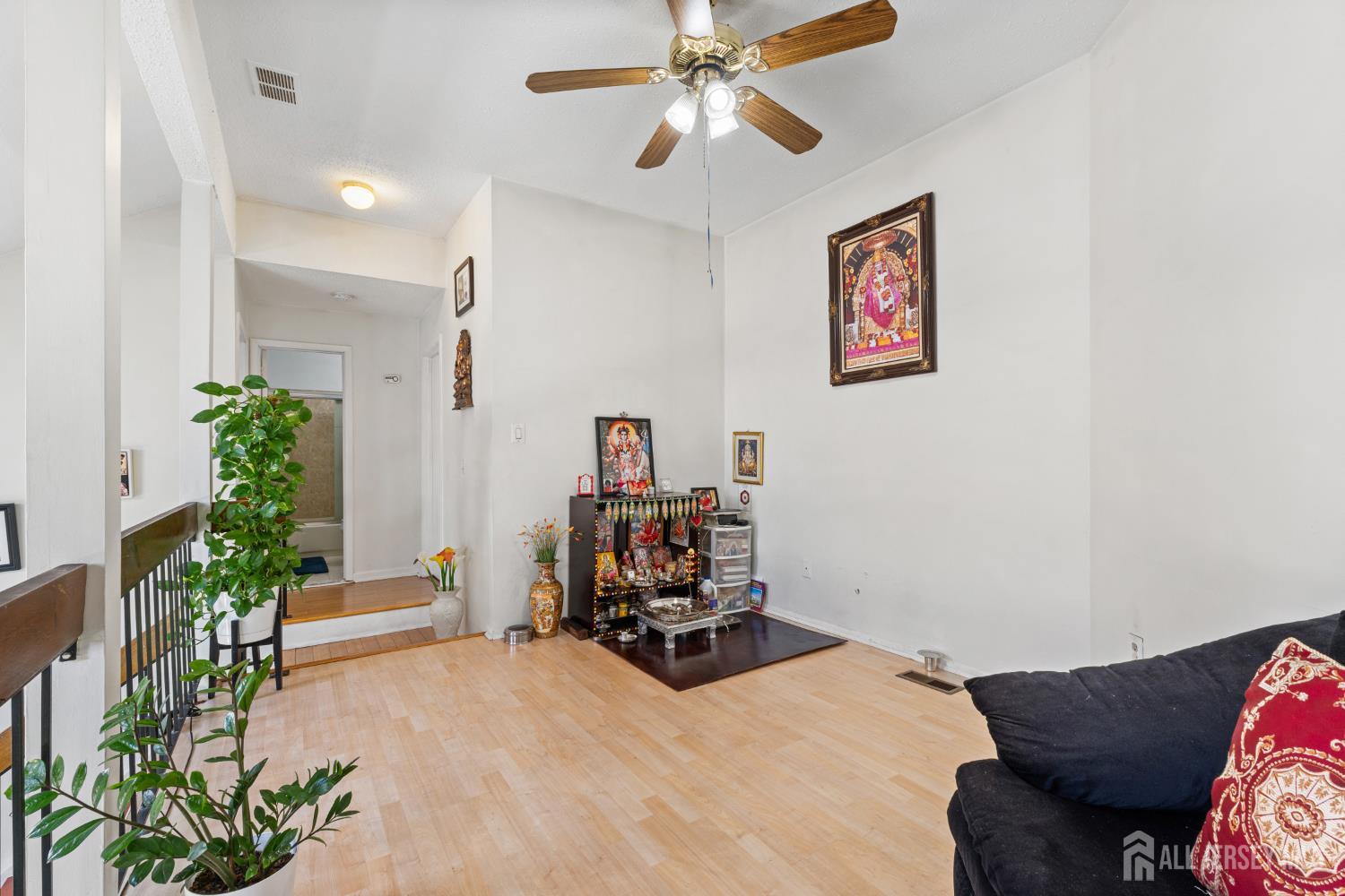 51 Westgate Drive Edison, NJ 08820 - Photo 27 of 48 a room with furniture and a potted plant