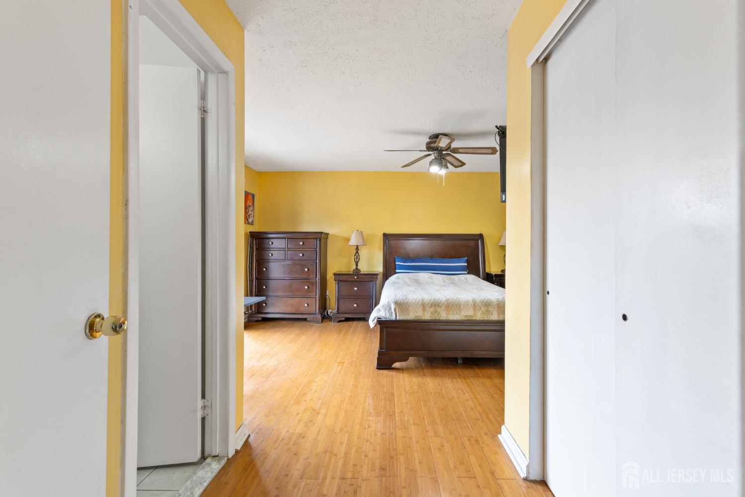 51 Westgate Drive Edison, NJ 08820 - Photo 37 of 48 a bedroom with a bed and wooden floor