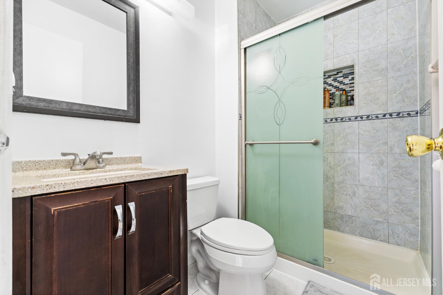 51 Westgate Drive Edison, NJ 08820 - Photo 38 of 48 a bathroom with a sink a toilet and shower