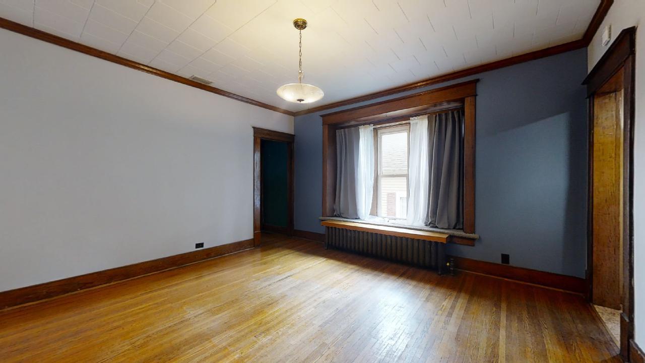 208 East State Street Fairmount, IL 61841 - Photo 11 of 42 a view of an empty room with wooden floor and a window