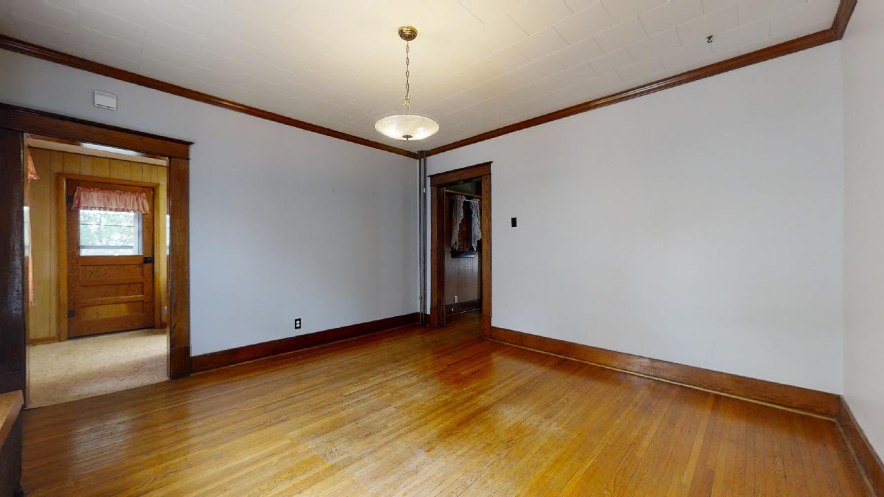 208 East State Street Fairmount, IL 61841 - Photo 13 of 42 a view of an empty room with window and wooden floor