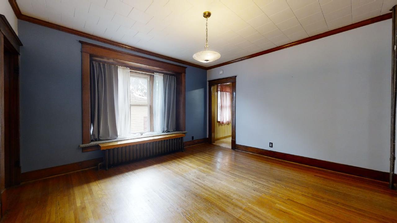 208 East State Street Fairmount, IL 61841 - Photo 14 of 42 a view of an empty room with wooden floor and a window