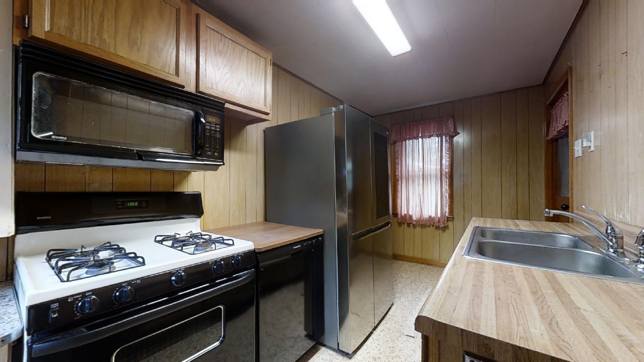 208 East State Street Fairmount, IL 61841 - Photo 17 of 42 a kitchen with a stove and a microwave