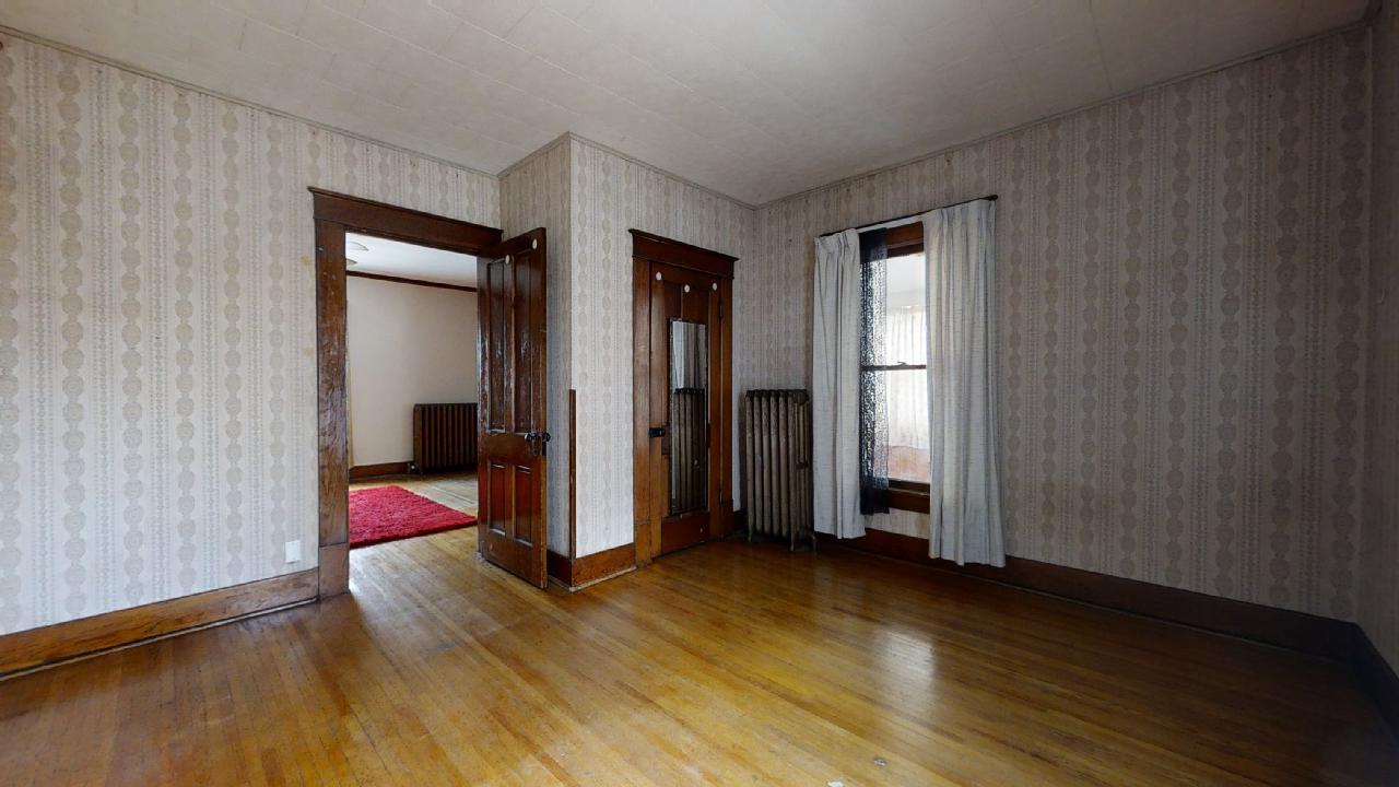 208 East State Street Fairmount, IL 61841 - Photo 20 of 42 an empty room with wooden floor and closet