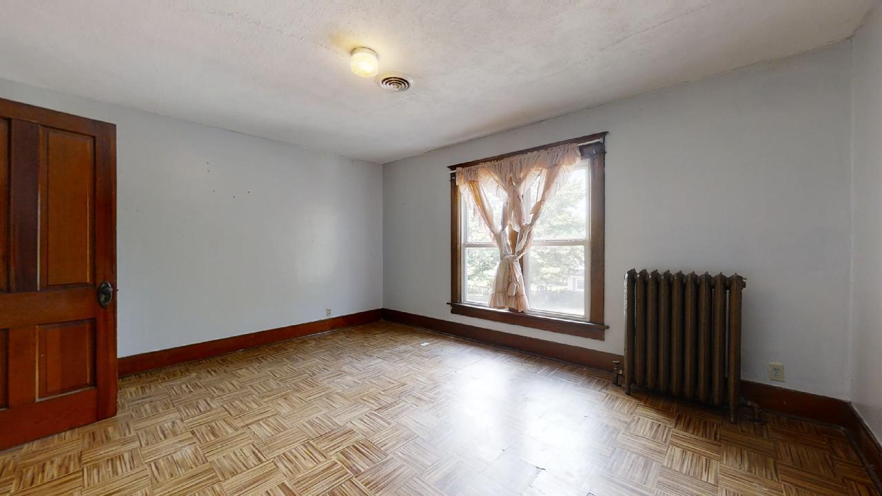 208 East State Street Fairmount, IL 61841 - Photo 24 of 42 an empty room with wooden floor and windows