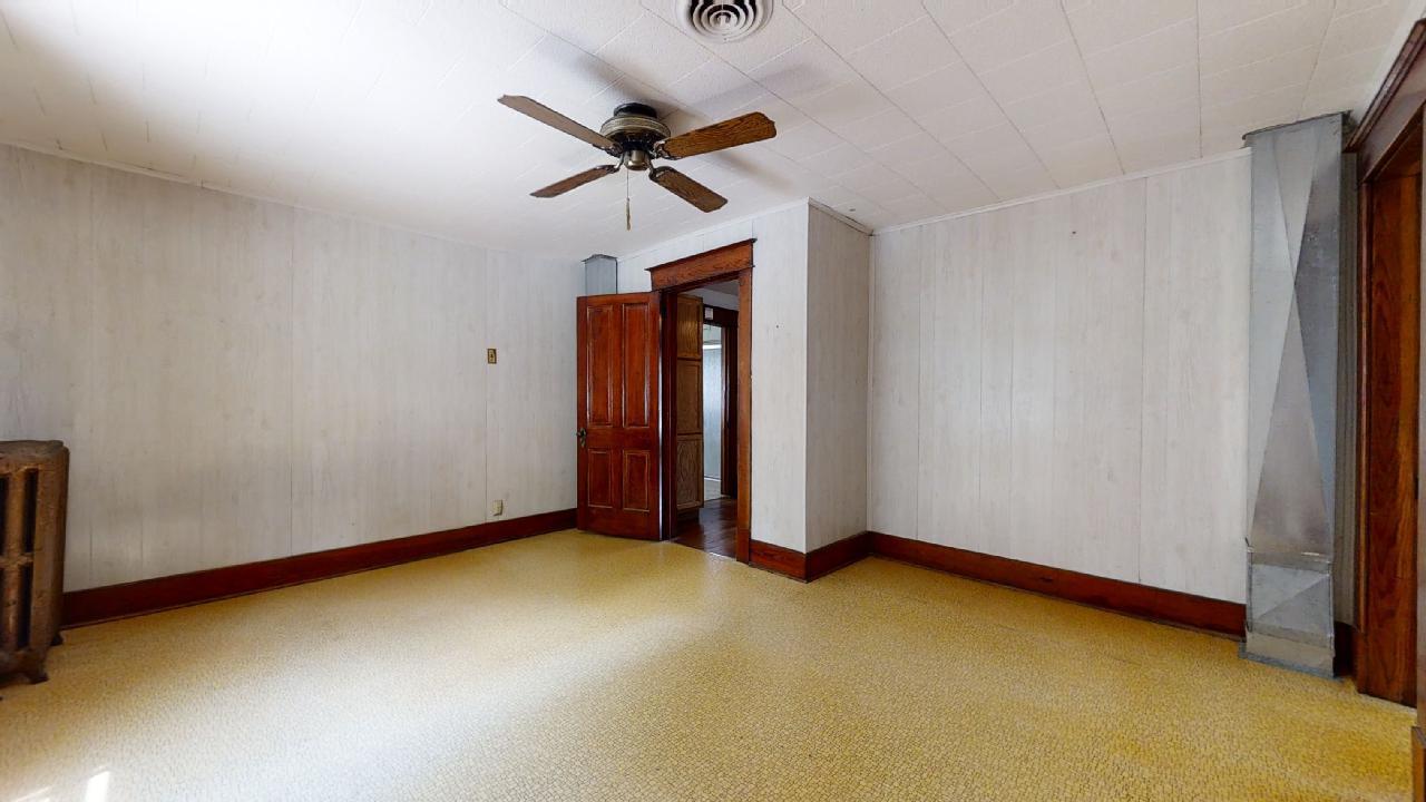 208 East State Street Fairmount, IL 61841 - Photo 29 of 42 a view of an empty room with window and a ceiling fan